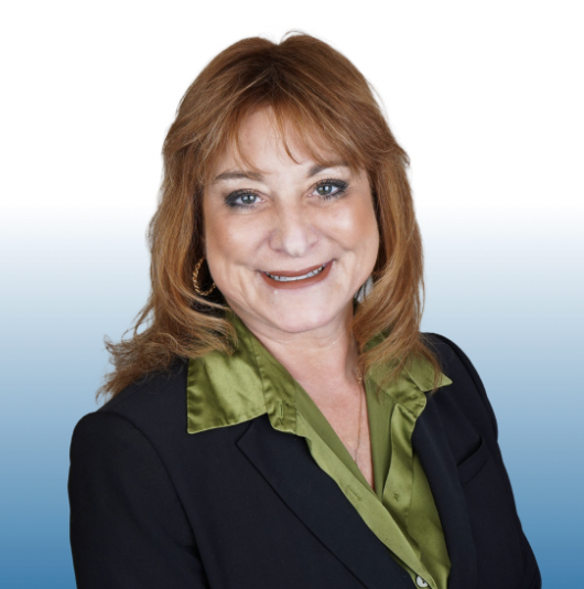 Professional headshot of a smiling Equity team member with auburn hair